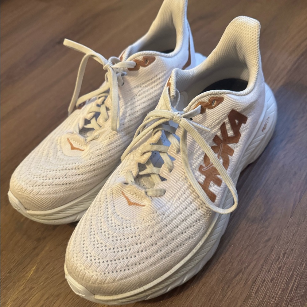 hokas. white and gold.